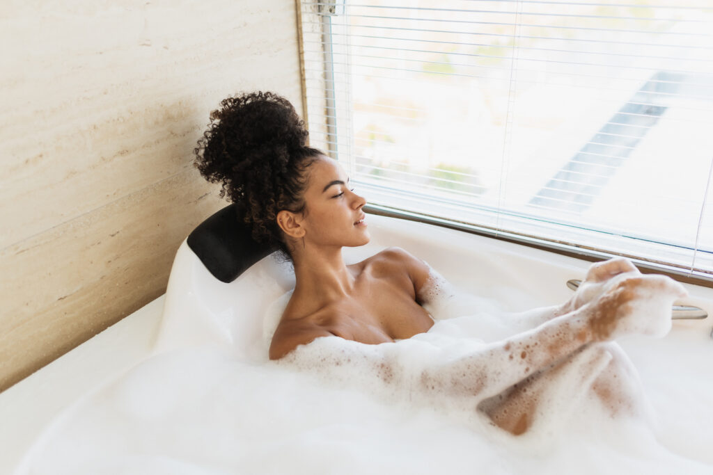 Beautiful lady soaking up in a luxury foam bath